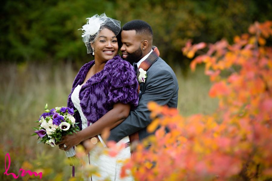 bride and groom with fall leaves