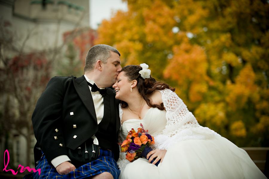 groom kissing bride outside the old courthouse in london ontario