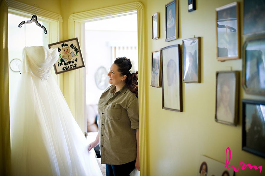 bride looking at dress before putting it on