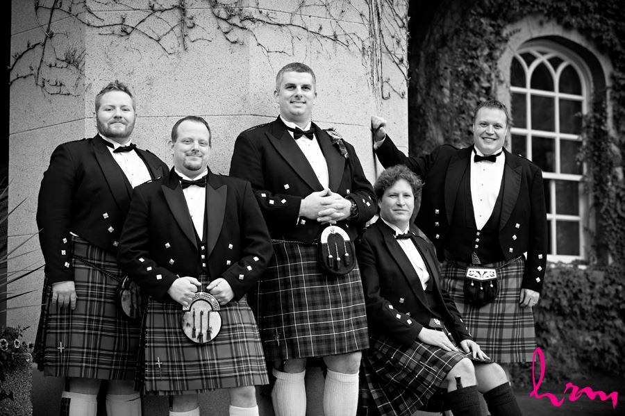 groom with his groomsmen with kilts outside the old courthouse