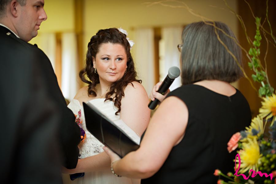 bride listening to officant speak at ceremony