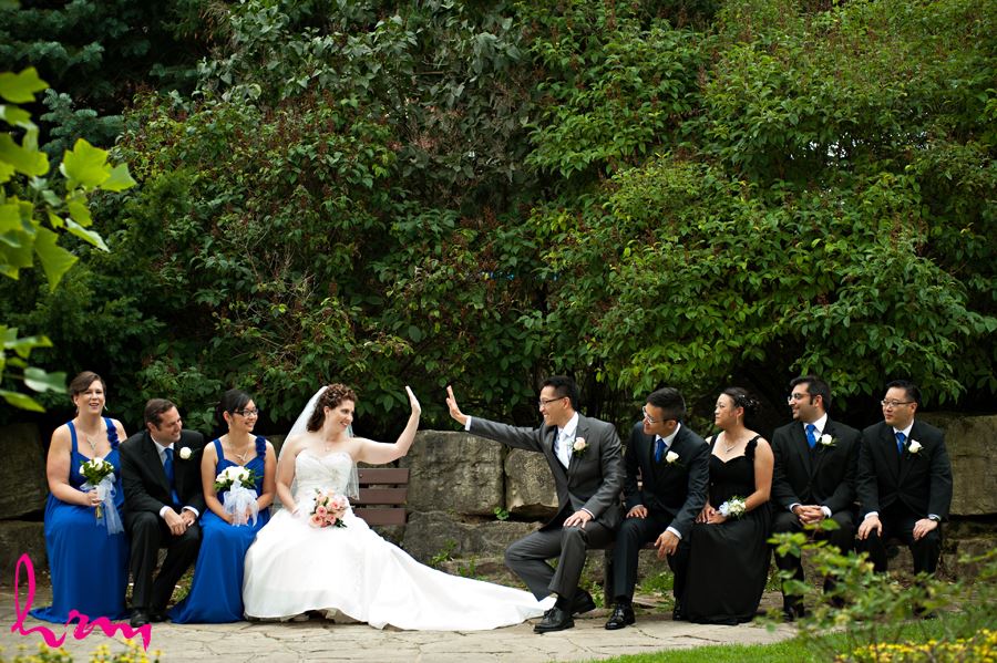 bride and groom high fives with wedding party