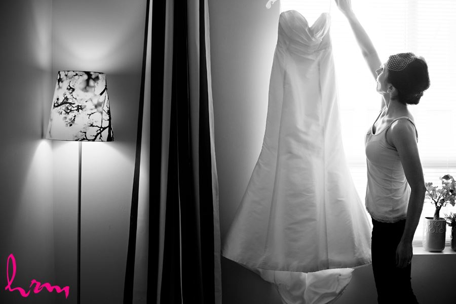 blacka and white bride reaching for dress