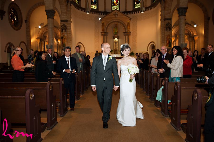 bride and groom walking down aisle after getting married