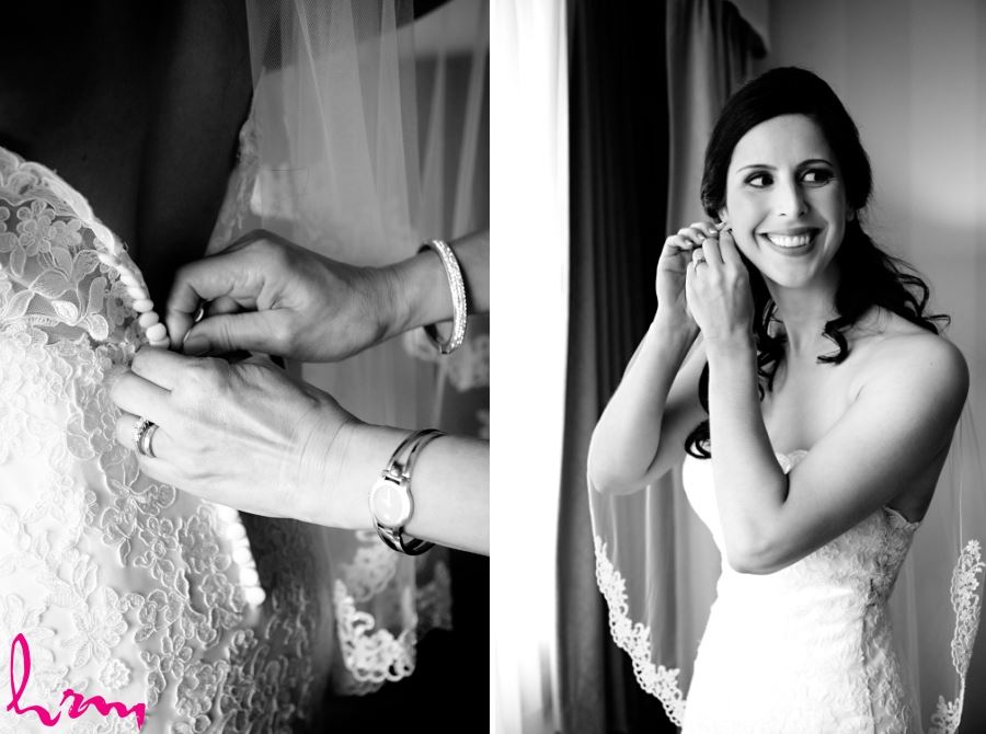 bride putting on earrings and putting on dress