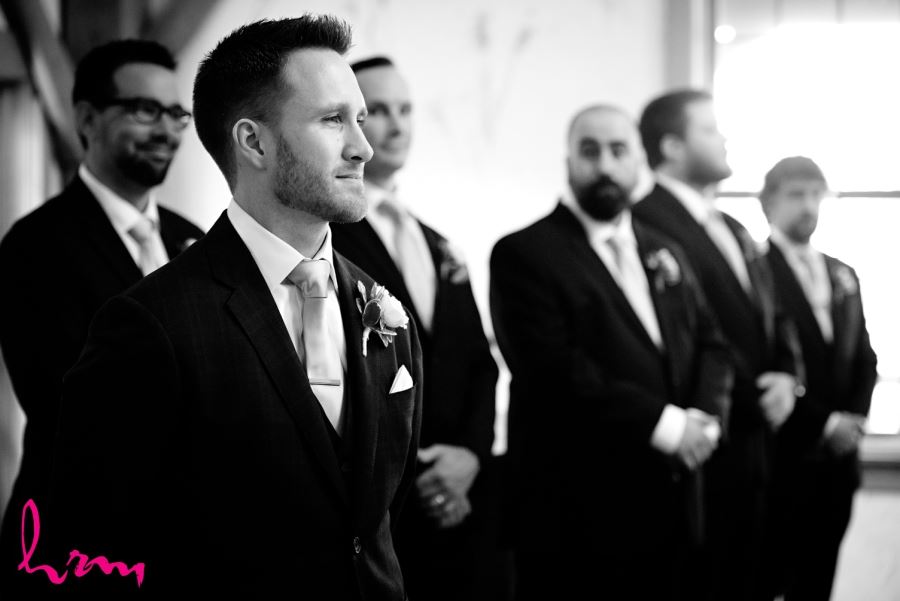groom standing with groomsmen during ceremony