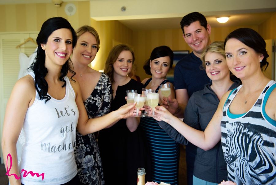 bride drinking champagne with bridesmaids