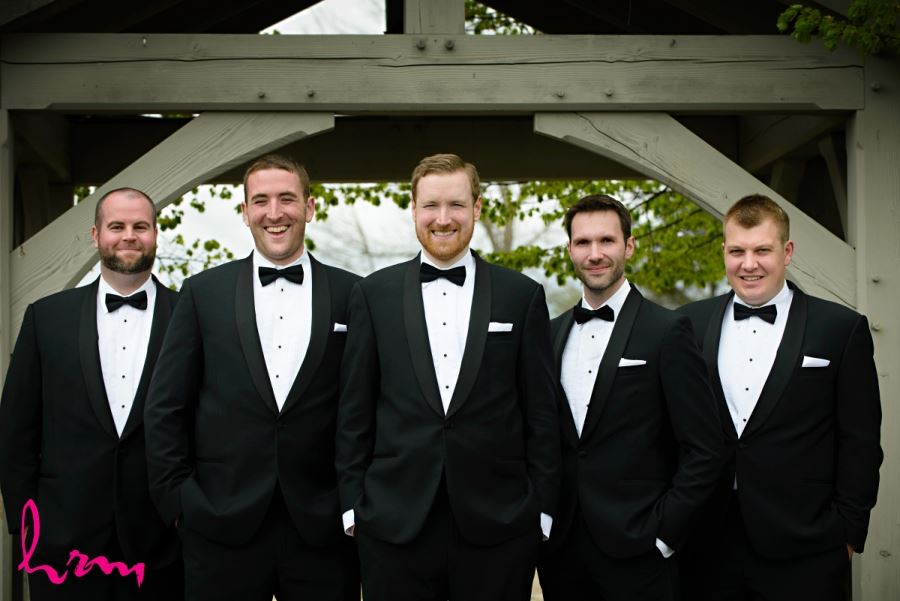 groomsmen in black suits with bow ties