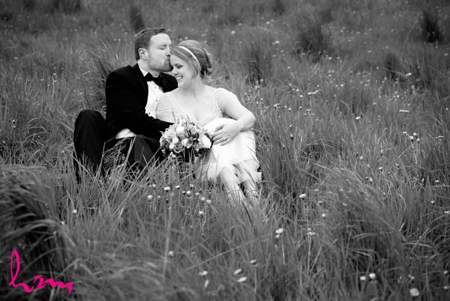 black and white bride and groom in field of grass