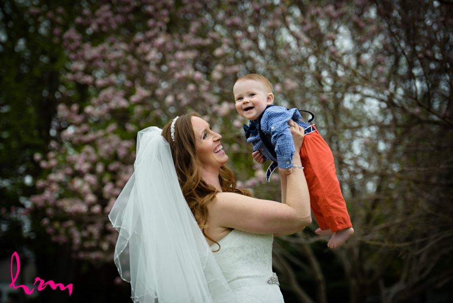 bride lifting baby in air