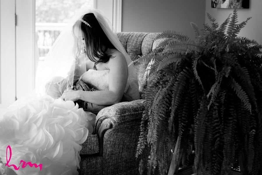 bride in dress nursing baby wedding day