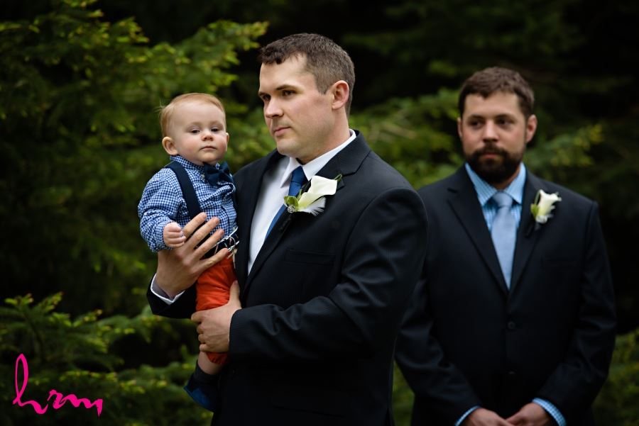 groom with baby during ceremony wedding day