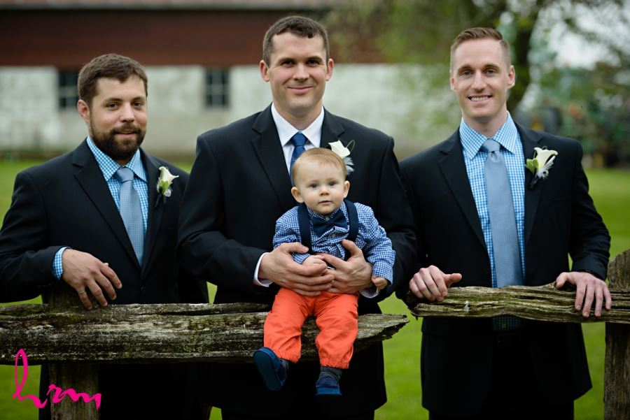 groom and groomsmen with baby