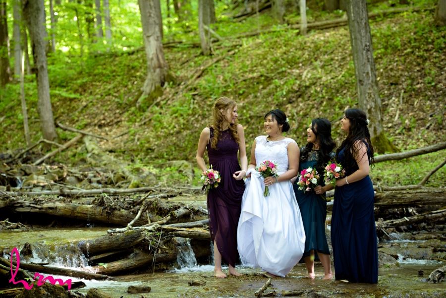 bride and bridesmaids in stream no shoes