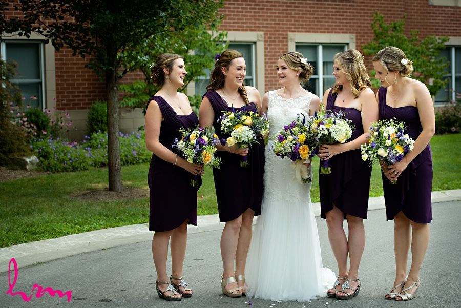 Claude and bridesmaids holding bouquets, taken by HRM photography