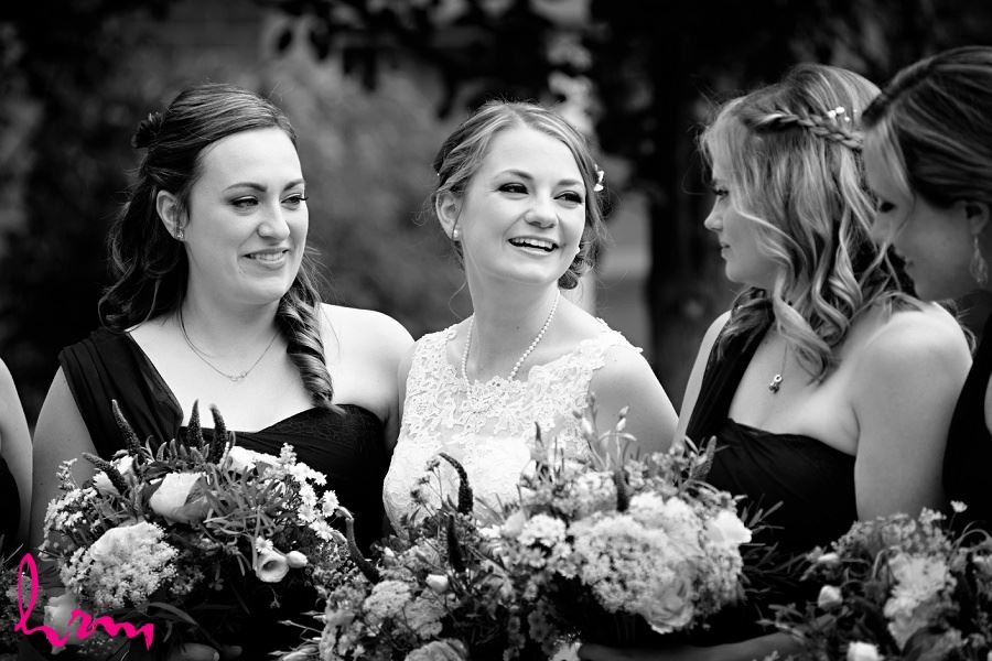 Blakc and white photo of Claude and bridesmaids holding bouquets, taken by HRM photography