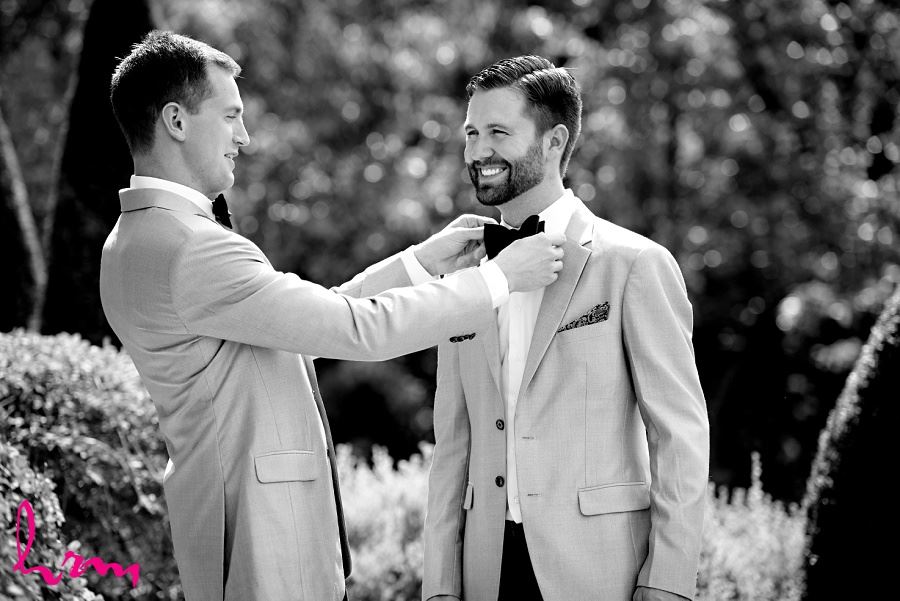 Black and white photo of bowtie fixing taken by HRM Photography London Ontario Wedding photographer
