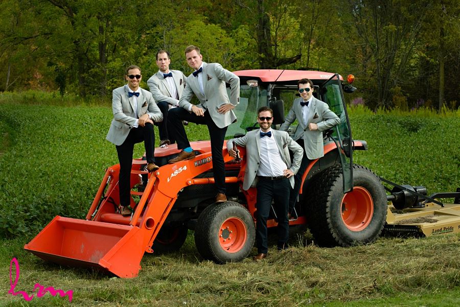 Photo of groomsmen and groom on tractor by London Ontario Wedding Photographer