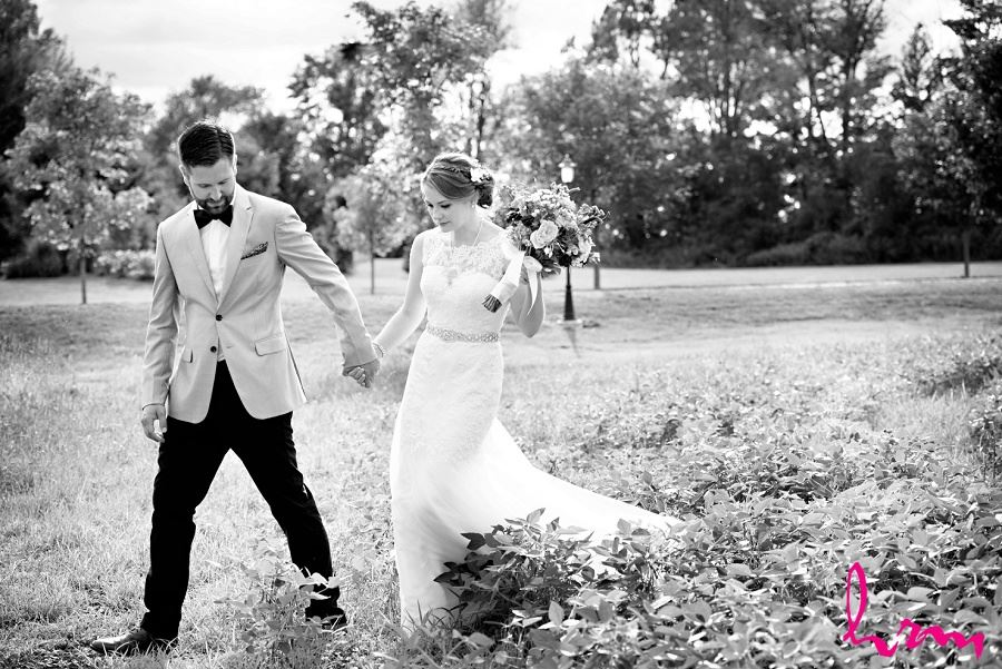 Black and white photo of bride and groom in field by London Ontario Wedding Photographer