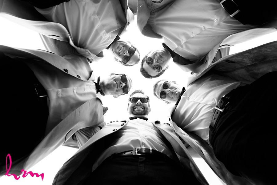 Photo of groomsmen in circle by London Ontario Wedding Photographer