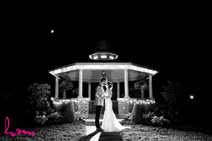 Black and white photo of bride and groom kissing at night taken by HRM Photography London Ontario wedding photographer