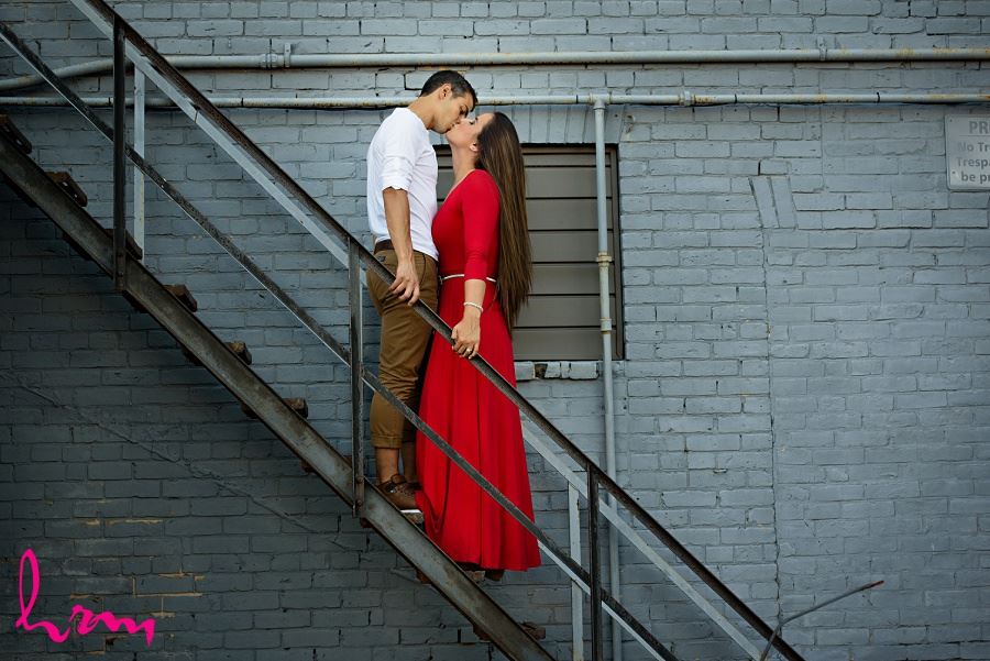 Kissing on stairs during London Ontario engagement photography session