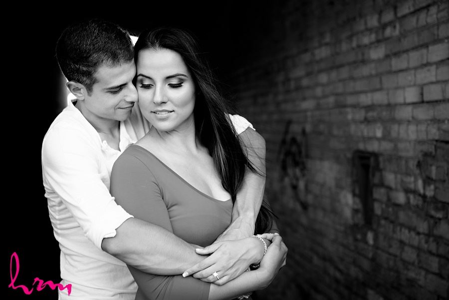 Black and white photo of Jessica and Ahmad in industrial setting taken during London Ontario engagement photography session