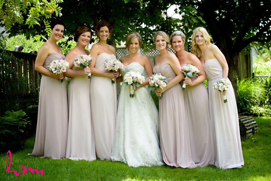 bridal party in different shades of dusty rose pink dresses