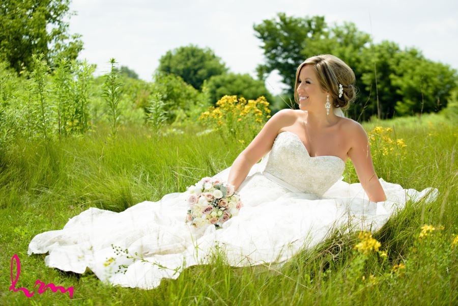 bride in meadow on sunny wedding day