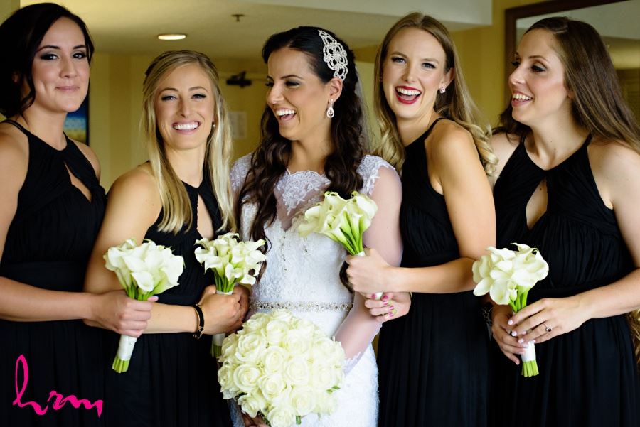 Bridesmaids in black with white bouquets