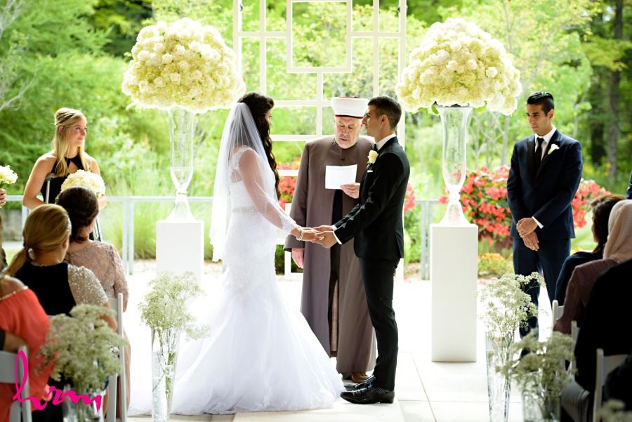 Wedding ceremony decor large bouquets at end of aisle