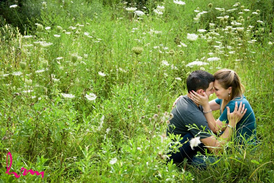 engagement session photography couple in field meadow of queen anne's lace