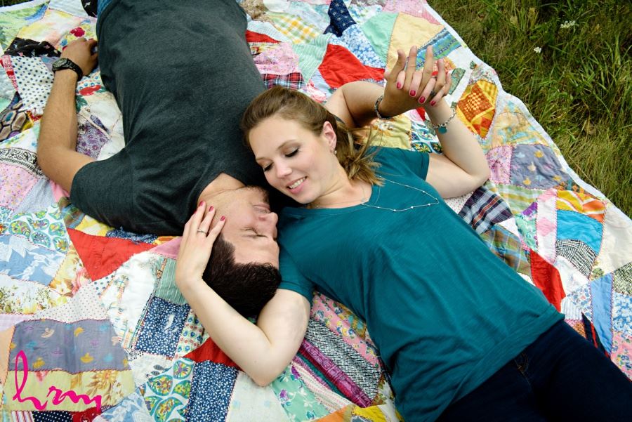 engagement session posing ideas laying on quilt