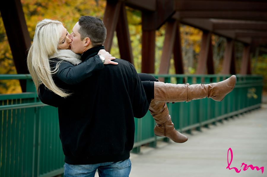 Stunning photo of engaged couple kissing on a bridge in London Ontario