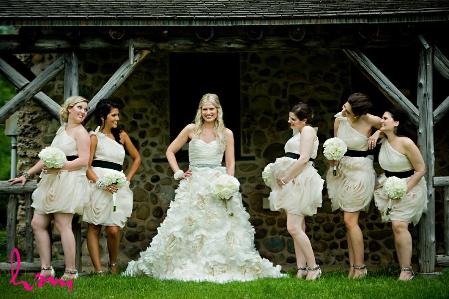 Wedding photo of bride and bridesmaids in rustic setting