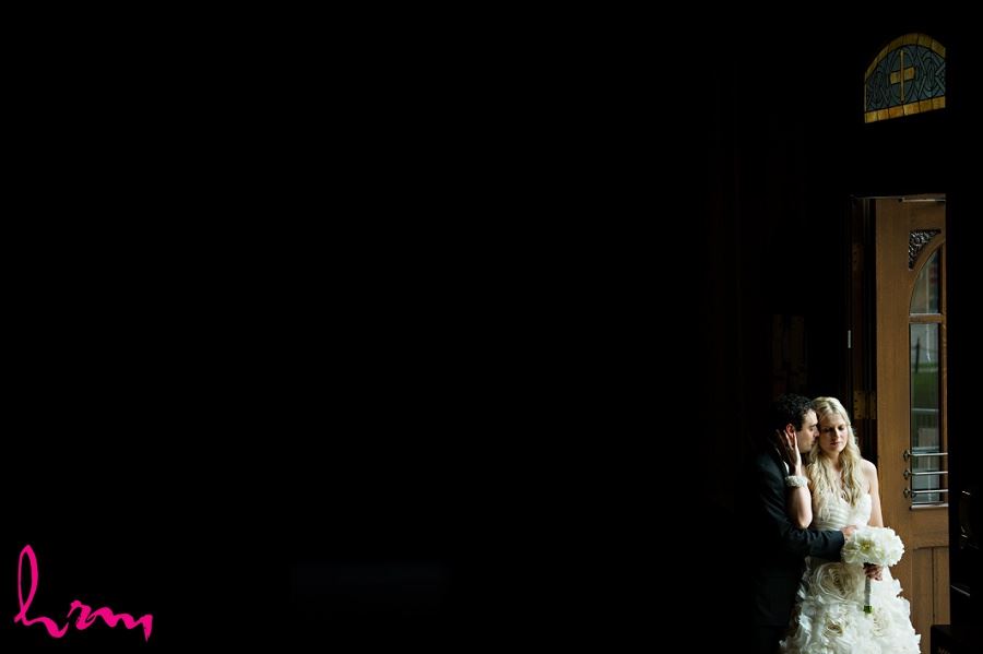 Photo of Ania and Ken in dark church taken by London Ontario wedding photographer