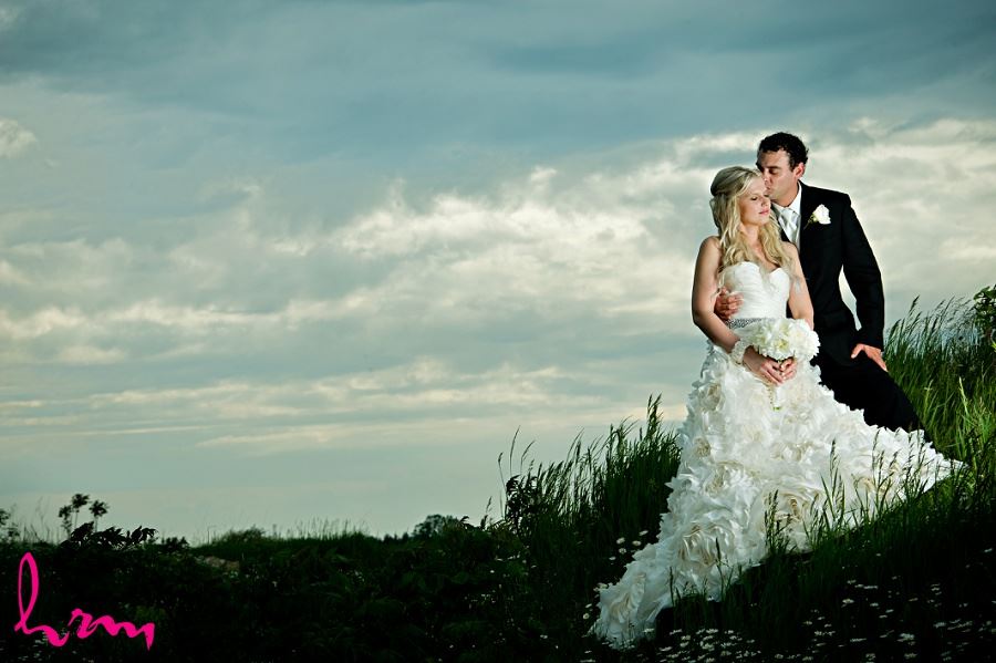 Photo of Ania and Ken on grass hill taken by London Ontario wedding photographer