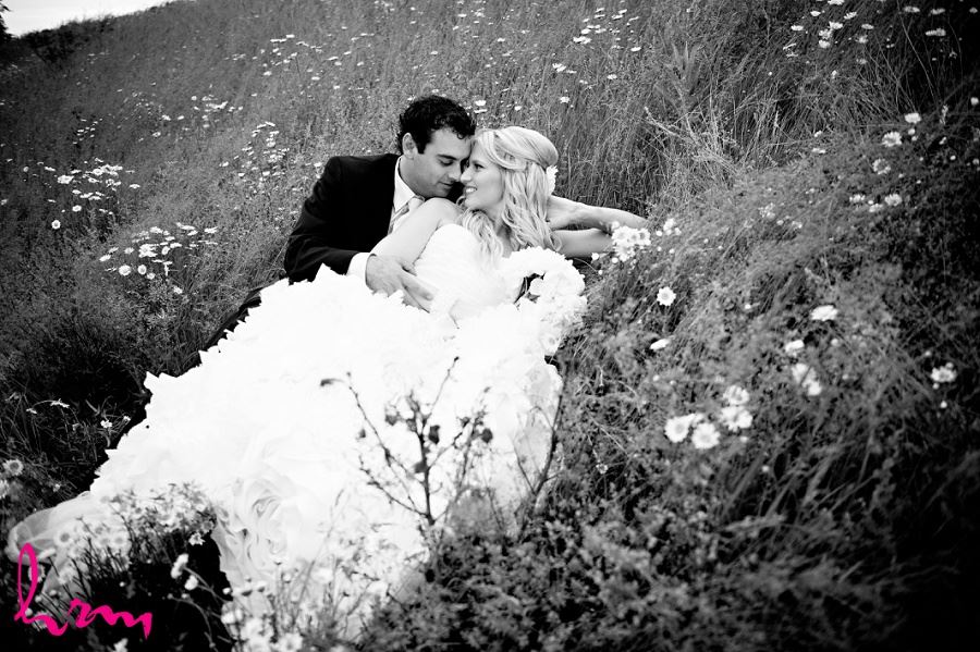 Black and white photo of Ken and Ania in grass taken by London Ontario wedding photographer