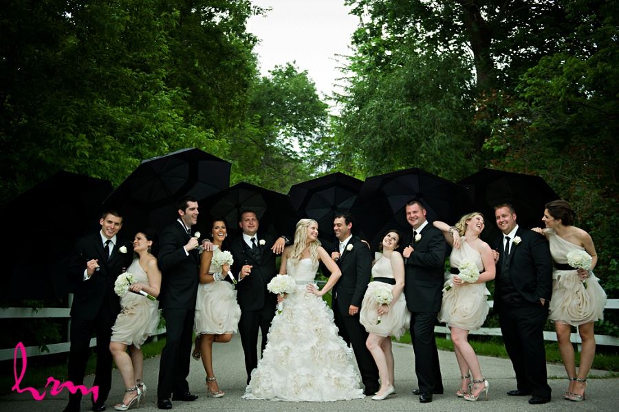 Bridal party with umbrellas taken by London Ontario wedding photographer