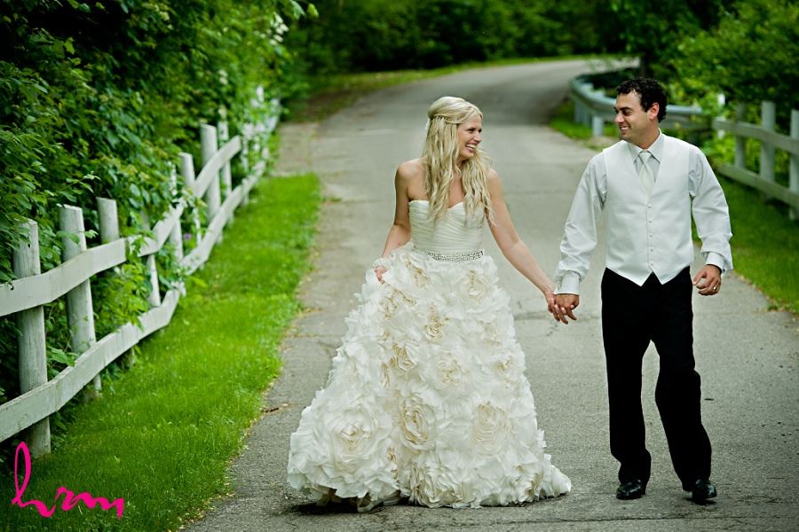 Wedding photo of bride and groom walking down road