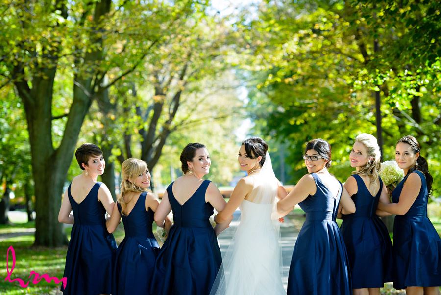 Geneviève and bridesmaids walking outside St. Peter's Cathedral London ON Wedding Photography