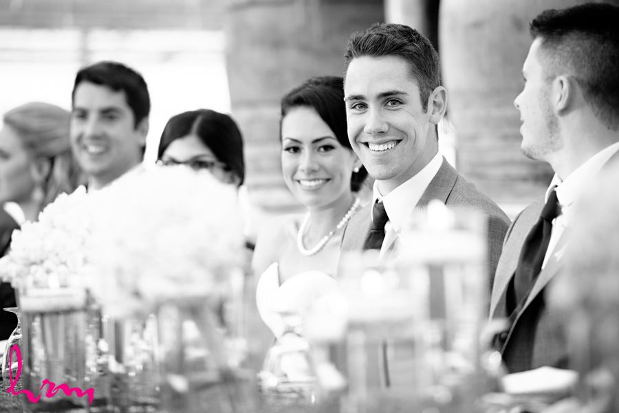 Bride and groom enjoying speeches at Heeman Greenhouses London ON Wedding HRM Photography
