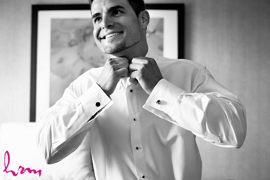 groom getting ready on wedding day in black and white