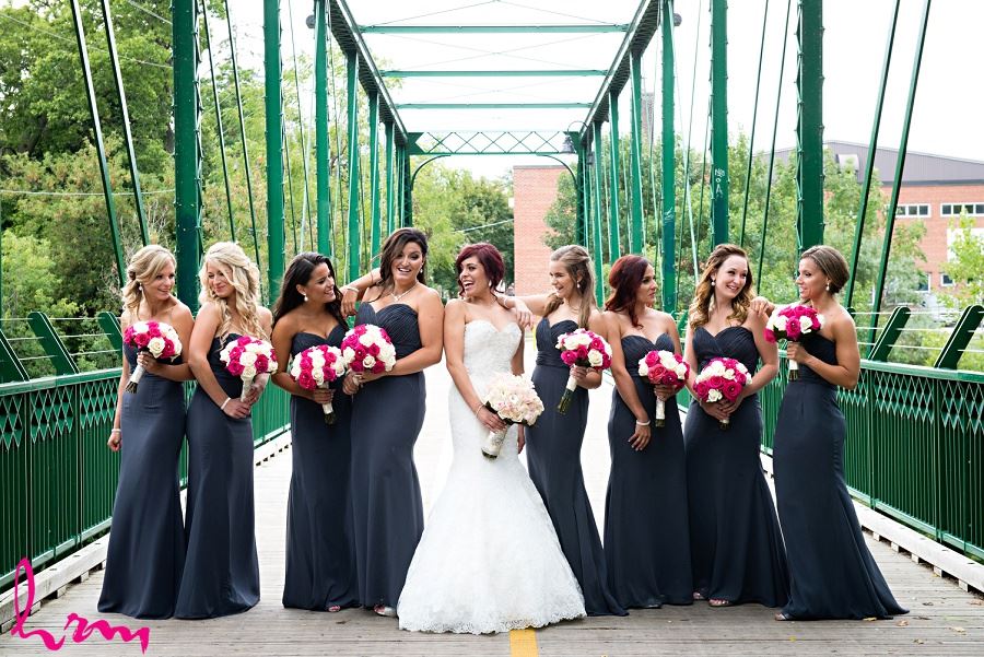 bridesmaids in dark gray charcoal with pink fuchsia bouquets