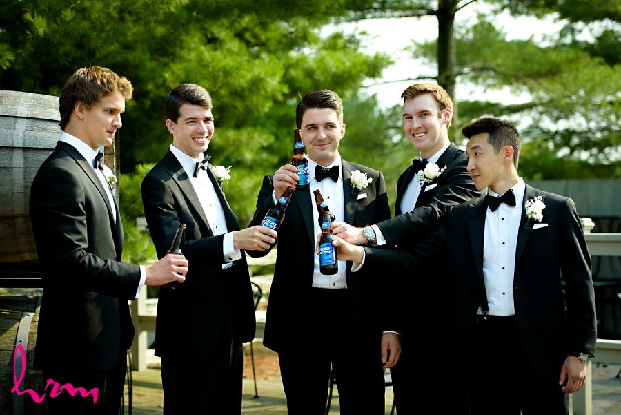 Groomsmen cheers at Bellamere Winery Event Centre London ON Wedding Photography