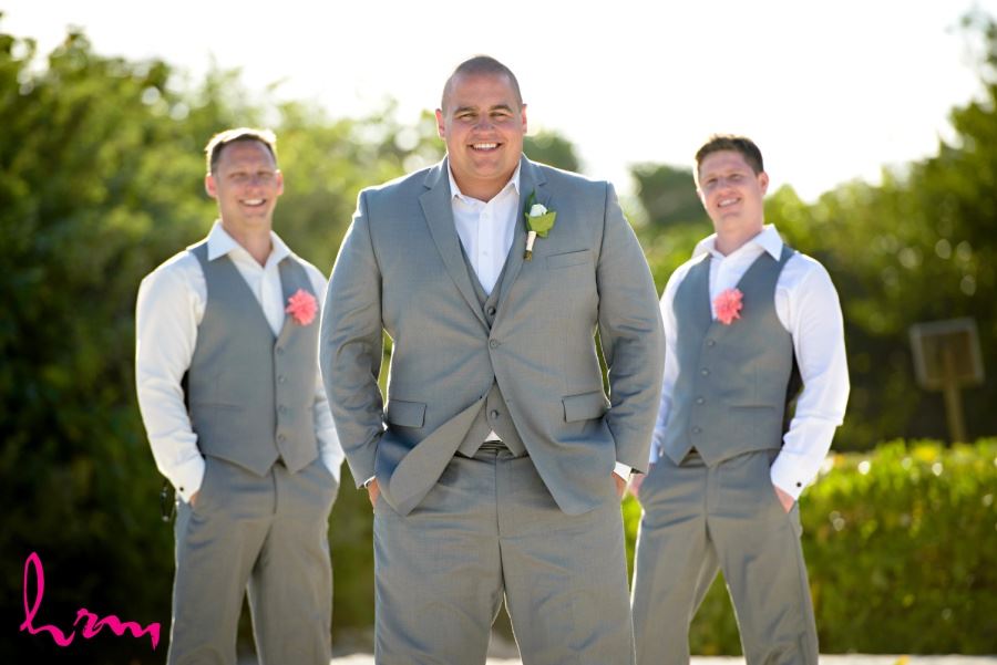 Groomsmen in gray suits with fabric boutineers