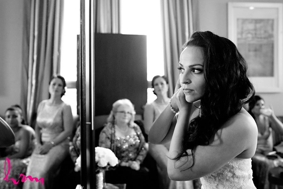 Lauren in black and white fixing earrings London ON Wedding Photography