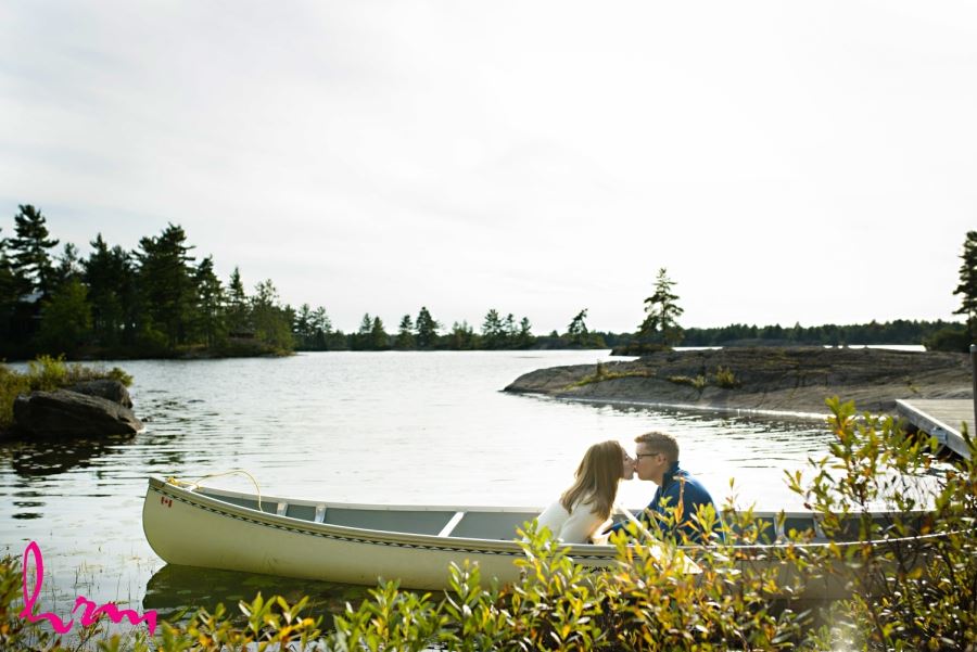 engagement session kissing in canoe