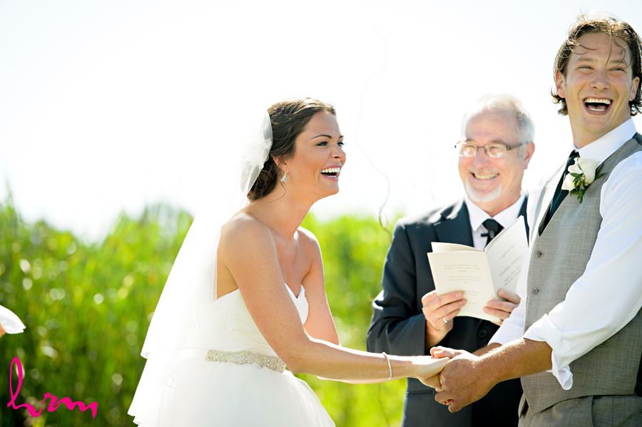 Laughing during ceremony at Purple Hill Country Farms London ON Wedding Photography