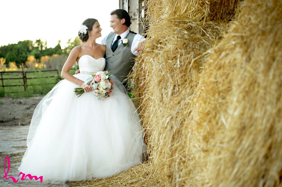 Leigh and Pete by hay bales Purple Hill Country Farms London ON Wedding Photography